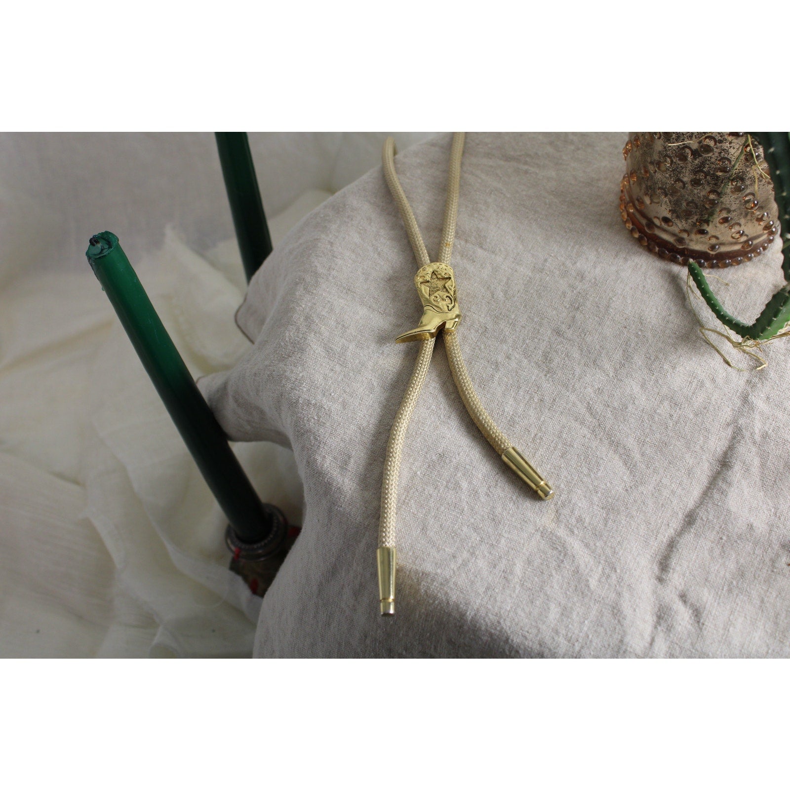 80s gold cowboy boot bolo tie