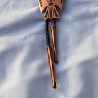 Front view of 70s copper thunderbird bolo tie slide