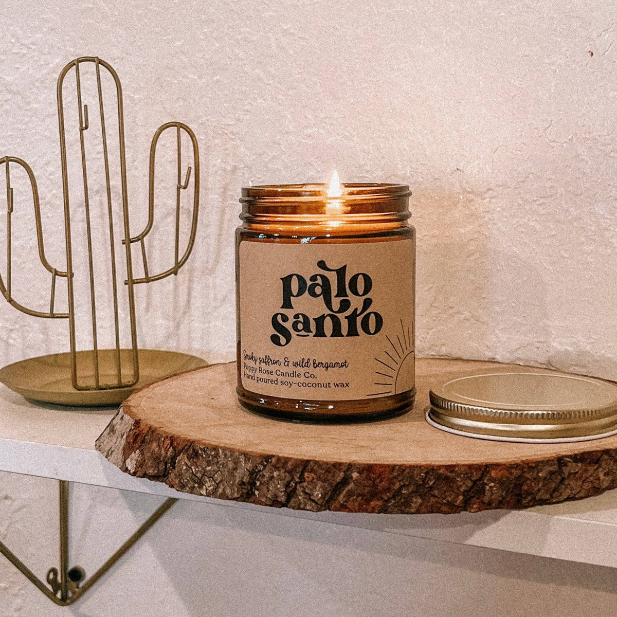 palo santo coconut wax candle in an amber glass jar