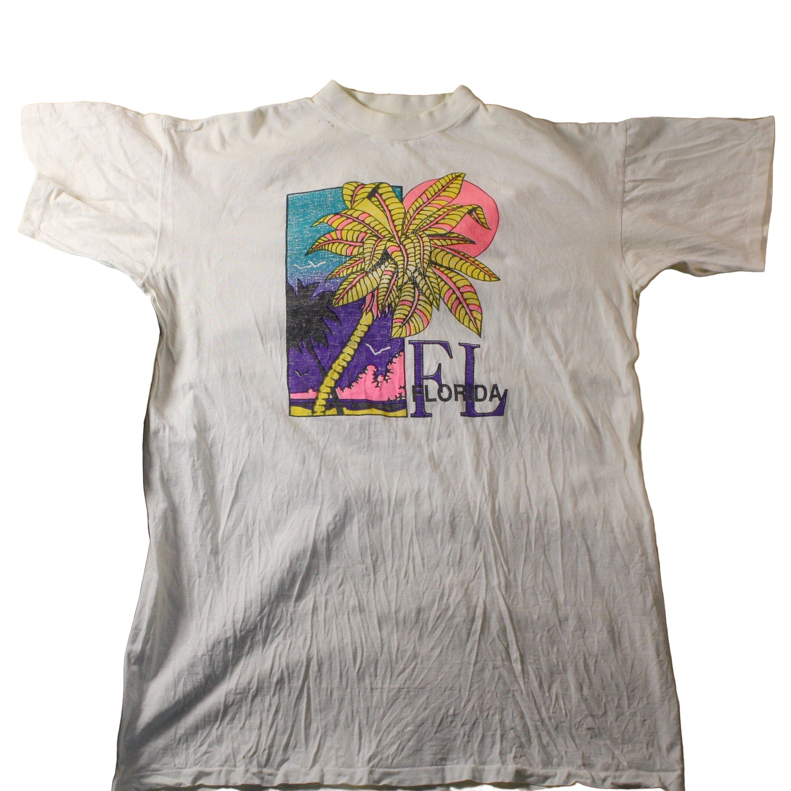 White t-shirt with a colorful palm tree design and 'FL' text on a textured surface.