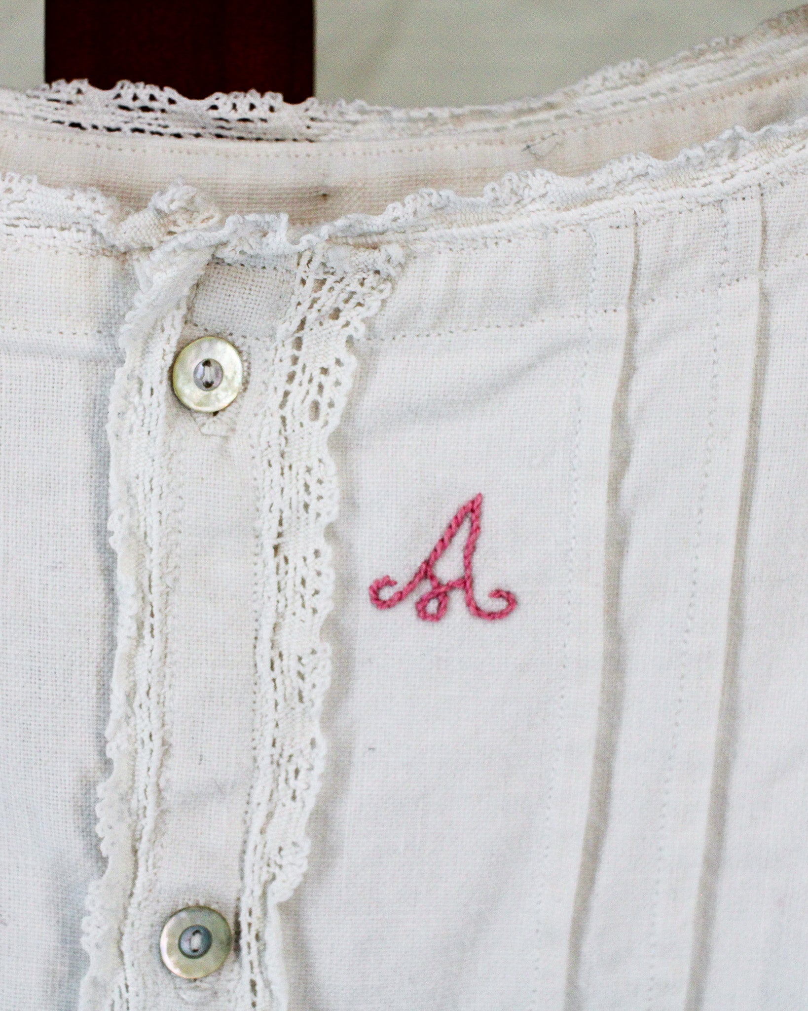 antique linen chemise, hand-monogrammed with mother-of-pearl buttons