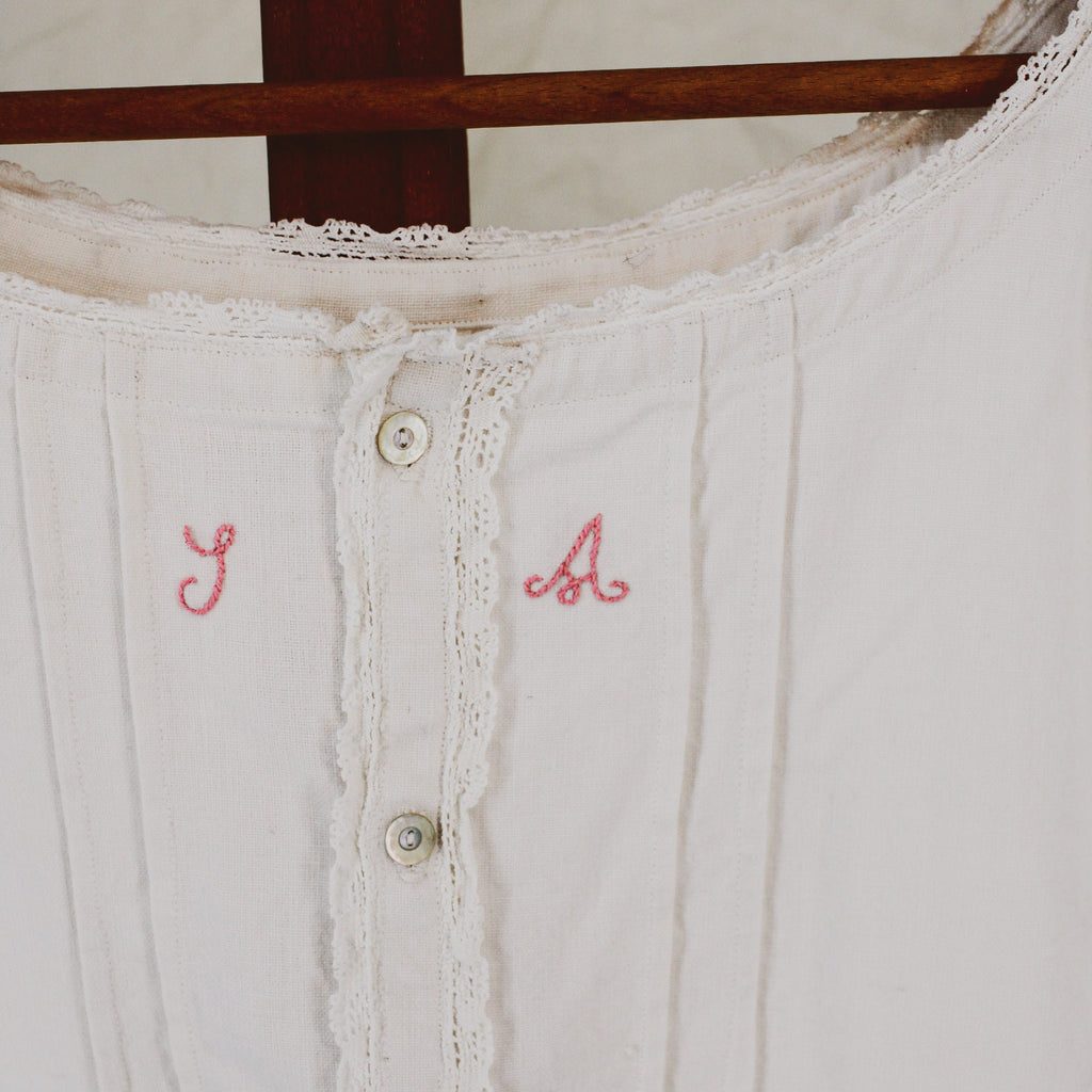 antique linen chemise, hand-monogrammed with mother-of-pearl buttons