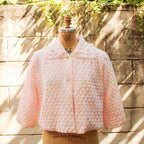 70s pink quilted bed jacket - front view on dress form