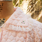 70s pink quilted bed jacket - back view on dress form