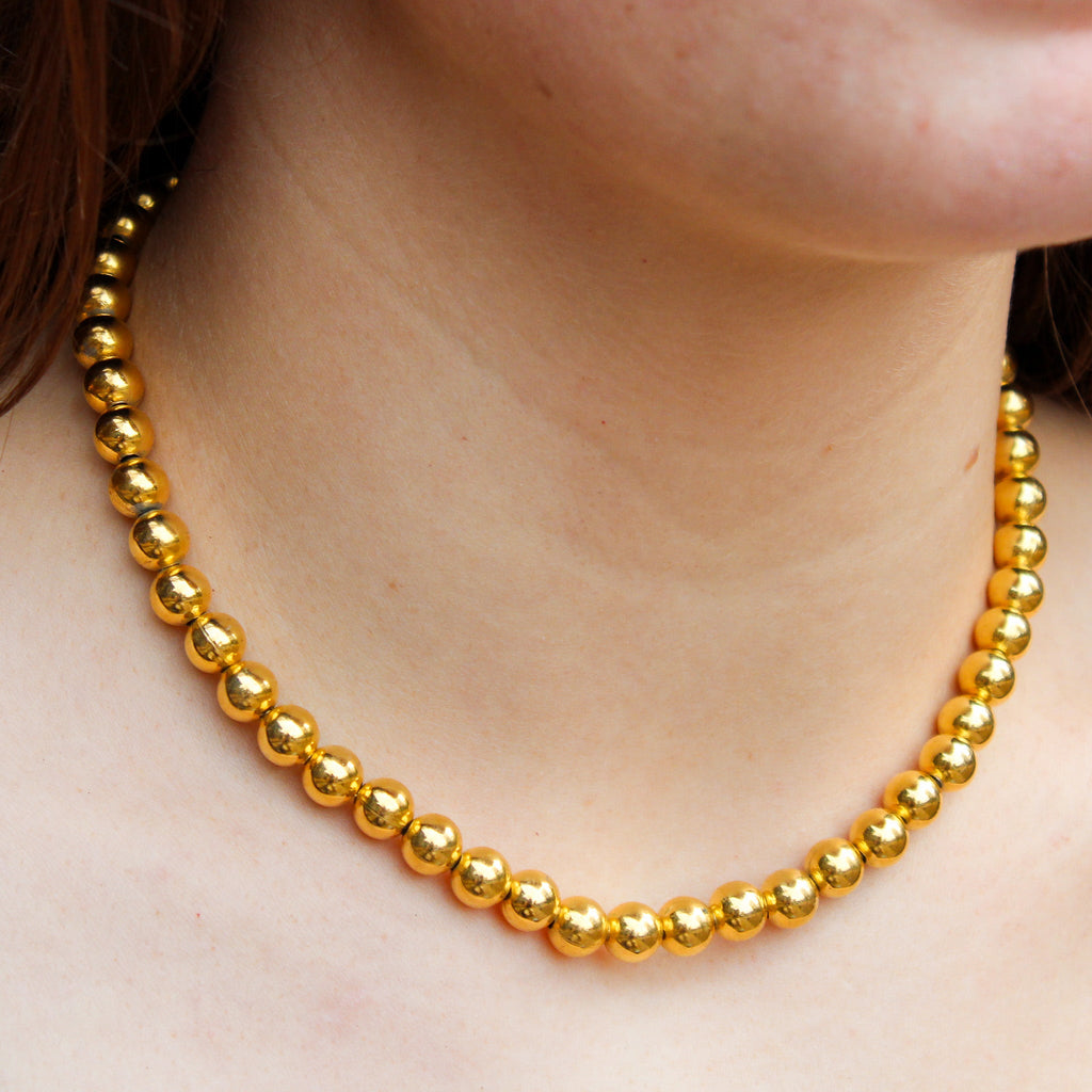 Front view of gold tone beaded choker