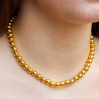 Front view of gold tone beaded choker