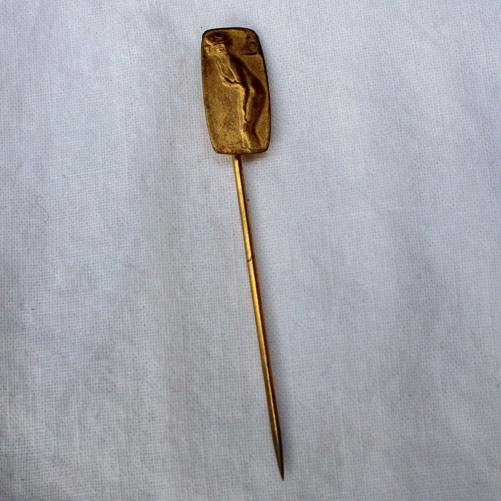 Back of brass lady stick pin showing patina