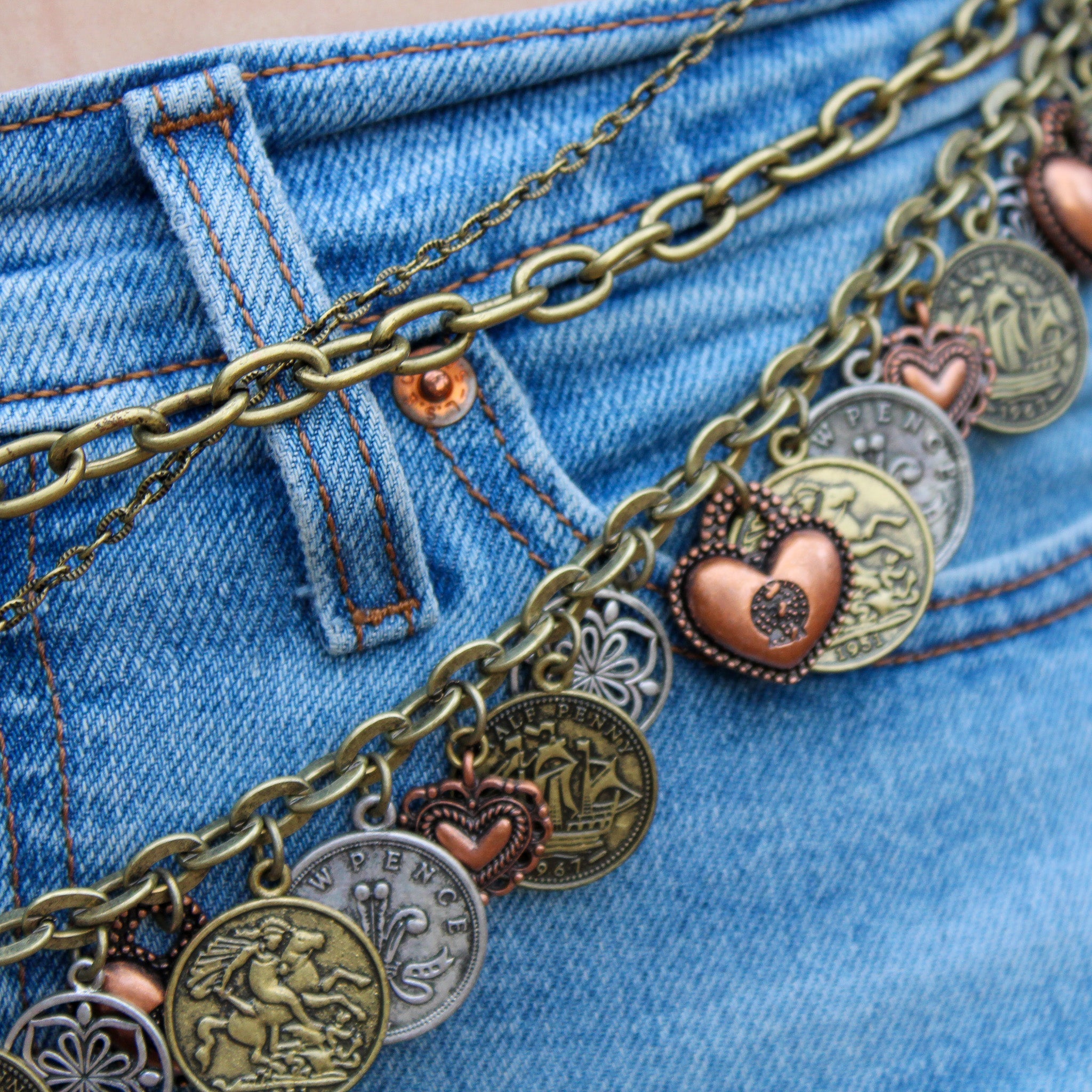 Detail of horse and coin charms on belt