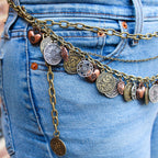 Side view of coin charm belt draped on hip