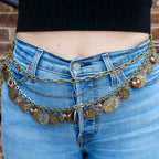 Close up of charms on coin charm belt