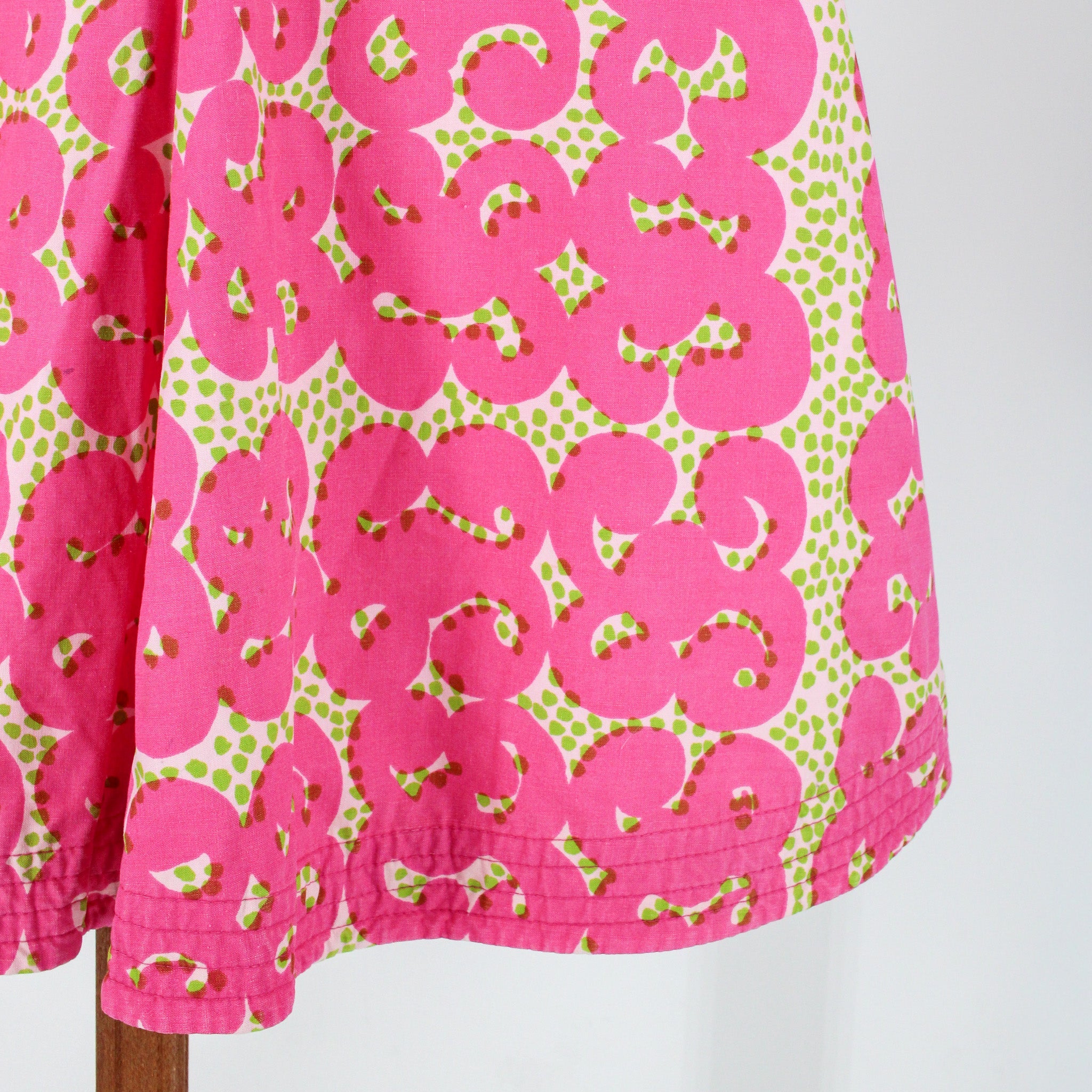 pink swirl print and pintucked hem detail