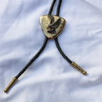 Full view of brass eagle bolo tie with braided cord and tips