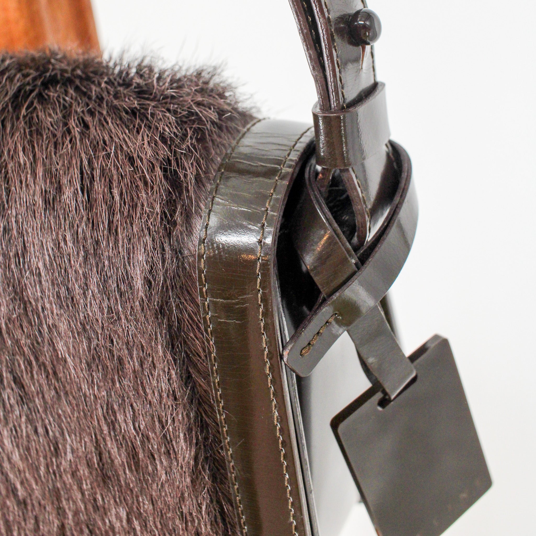 side profile with strap buckle and tag