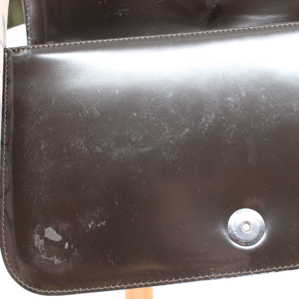 patent leather flap showing scratches and scuffs
