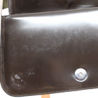 patent leather flap showing scratches and scuffs