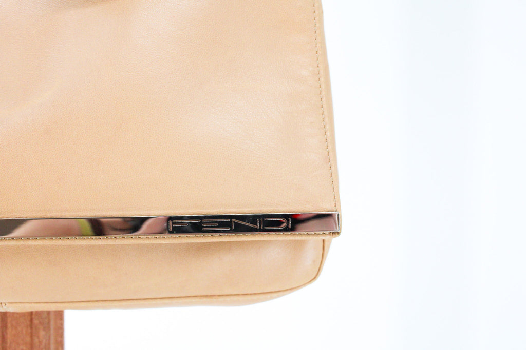 silver metal bar spelling fendi on the front flap