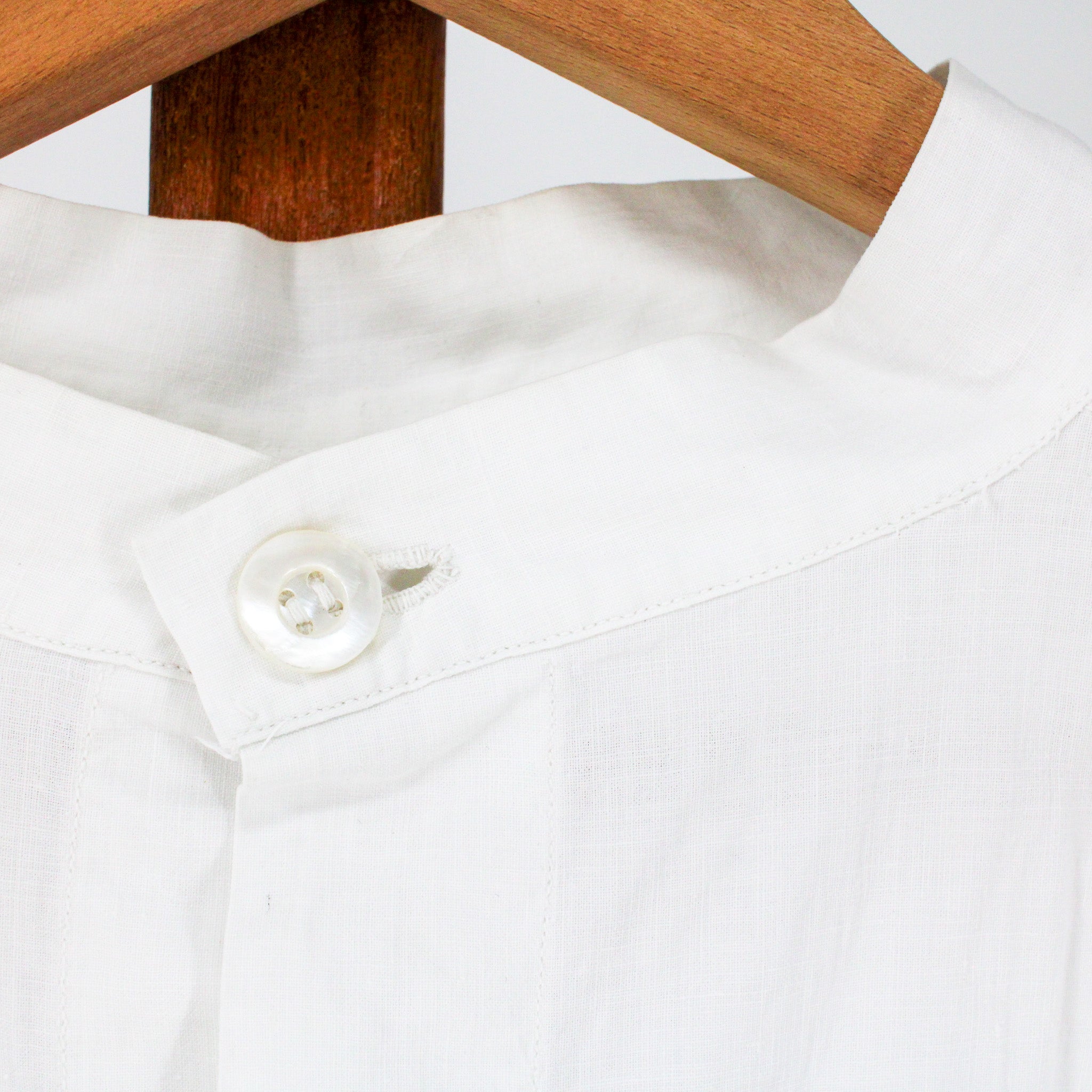 stand collar and mother-of-pearl neck button