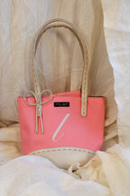 early 2000s kate spade new york pink monogram “l” tote bag with leather base, handles, and bow