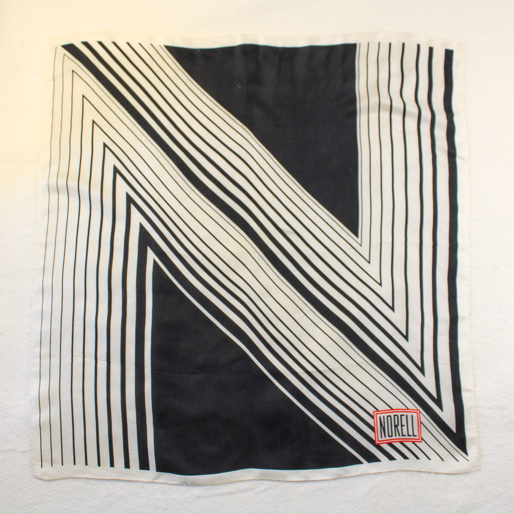 vintage norman norell “n” graphic silk scarf – black & white with red logo