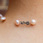 Front view of floating pink pearl necklace