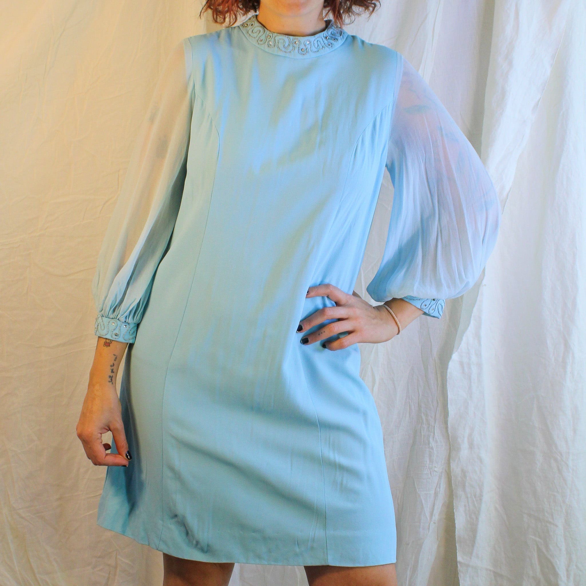 Front view on model of powder blue mock neck mini dress