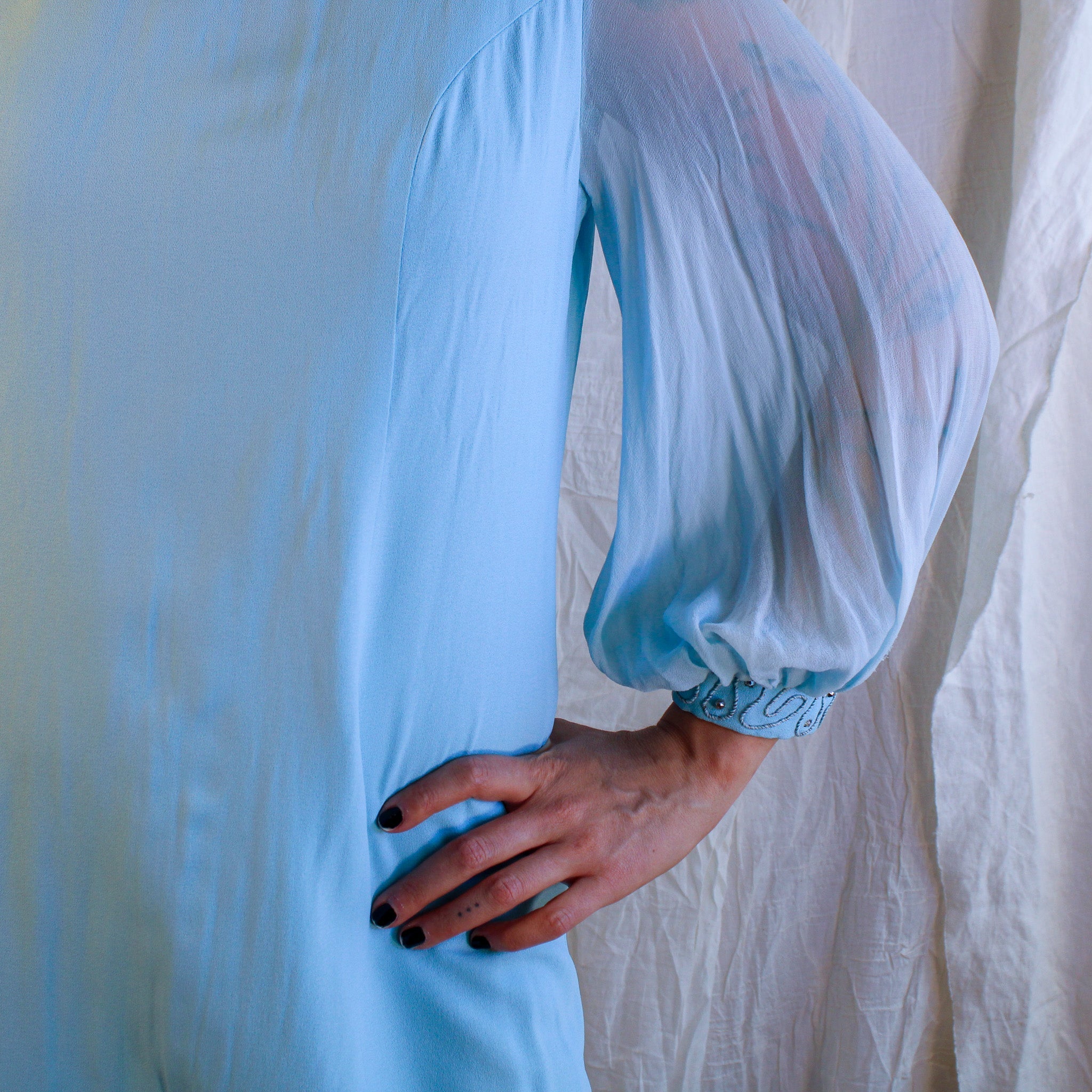 Close-up of crepe body and sheer sleeve