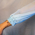 Detail of beaded cuff and sheer bishop sleeve