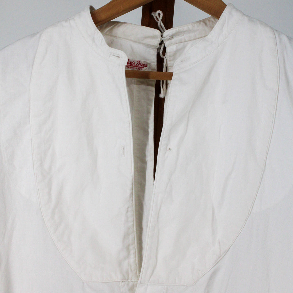 stand collar, neck tie, and bib bosom detail