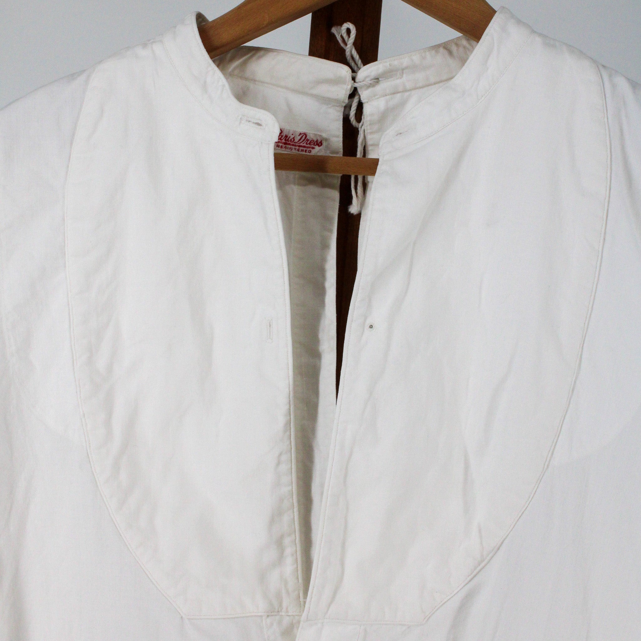 stand collar, neck tie, and bib bosom detail