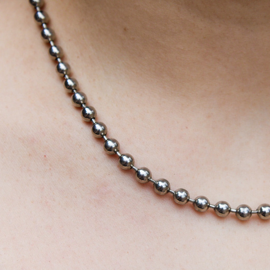 Close up of 90s silver ball chain choker on neck