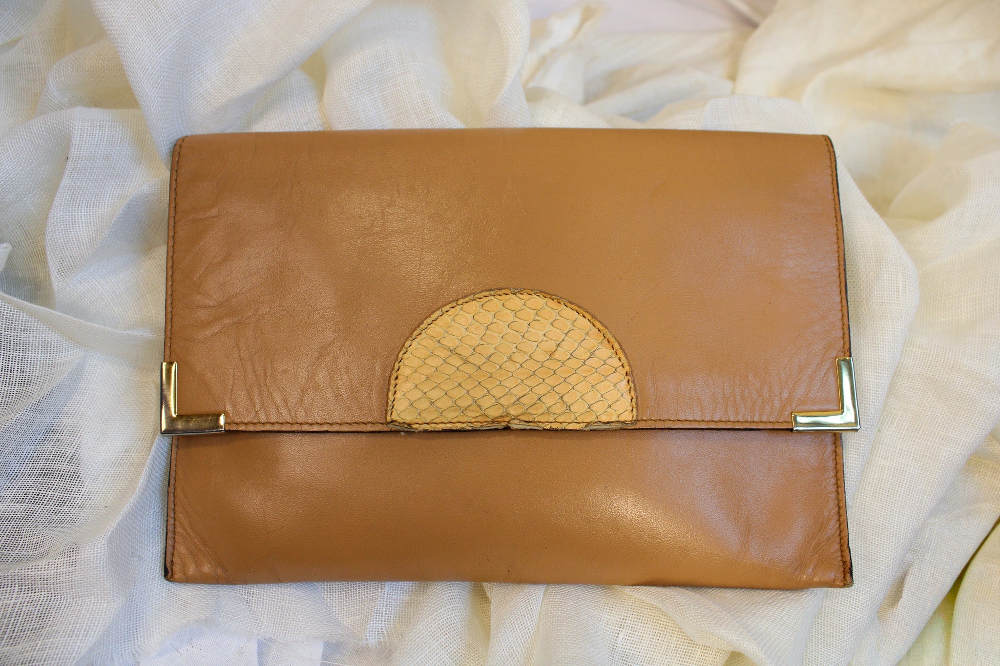 Front view of tan fold-over clutch