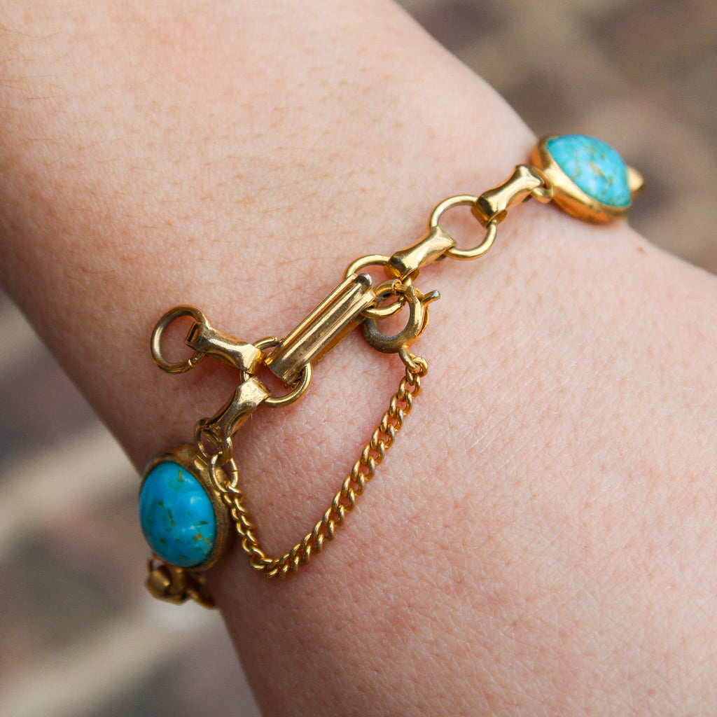 Clasp and safety chain detail on faux turquoise bracelet