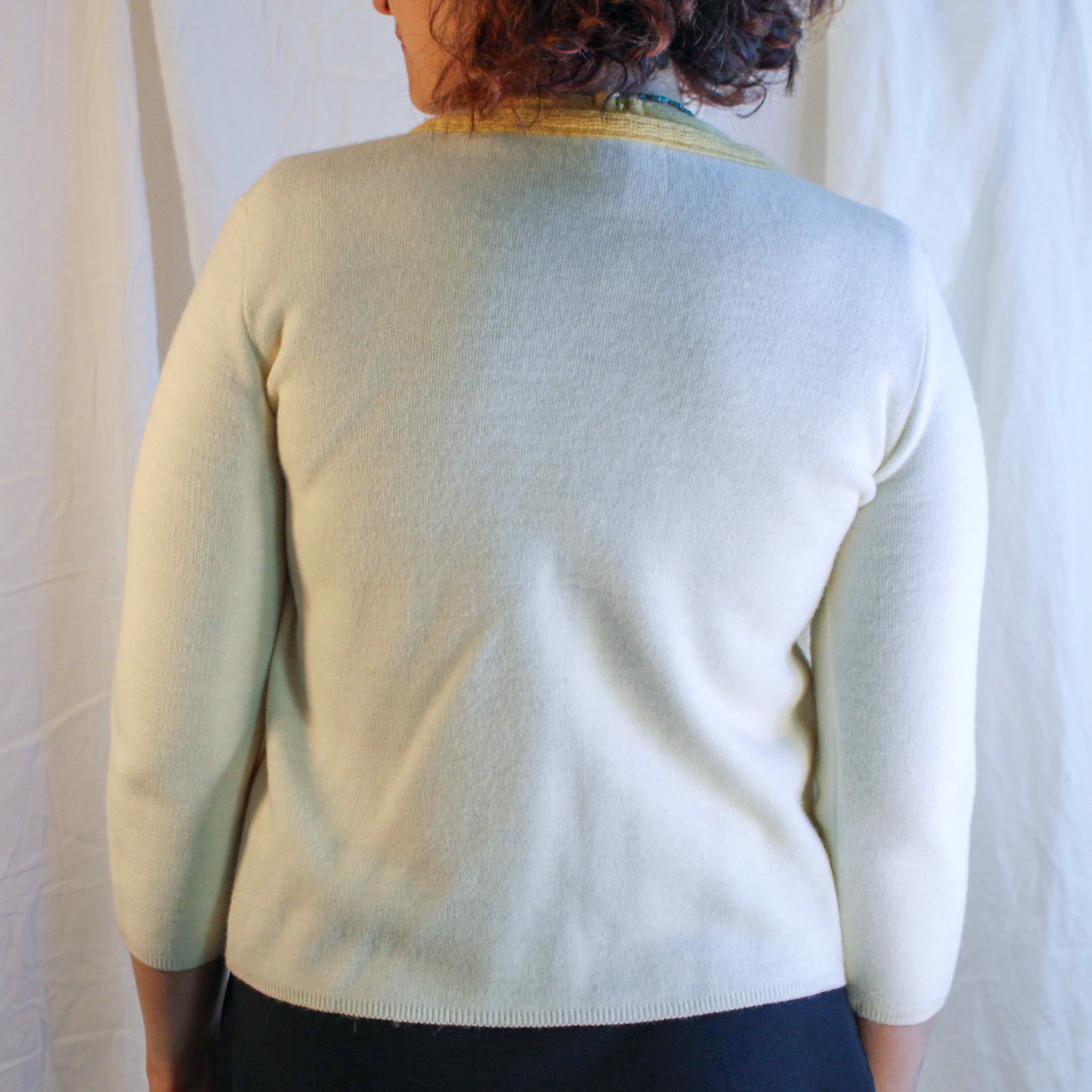 Front view on model of ivory and yellow wool embroidered cardigan