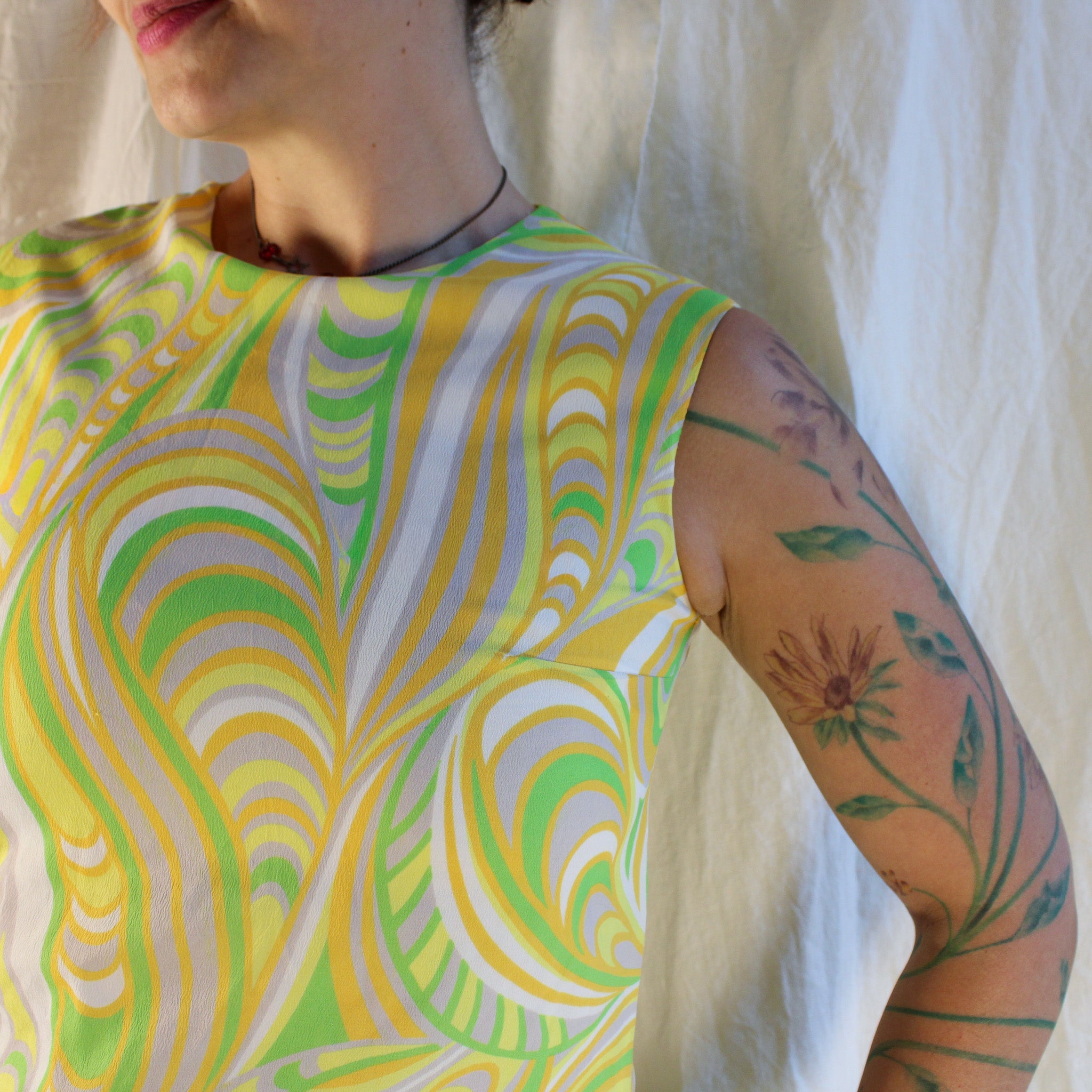 Front view of yellow green psychedelic sheath dress