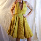 Front on model, quilted halter circle dress